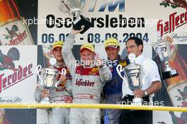 08.08.2004 Oschersleben, Germany,  DTM, Sunday, Podium, Tom Kristensen (DNK), Audi Sport Team Abt Sportsline, Portrait (1st, center), Martin Tomczyk (GER), Audi Sport Team Abt, Portrait (2nd, left), Manuel Reuter (GER), OPC Team Holzer, Portrait (3rd, right). Far right: Hans-Jurgen Abt (GER), Teamchef Abt-Audi (winning constructor) - DTM Season 2004 at Motopark Oschersleben (Deutsche Tourenwagen Masters)