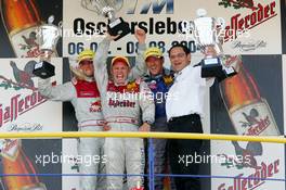 08.08.2004 Oschersleben, Germany,  DTM, Sunday, Podium, Tom Kristensen (DNK), Audi Sport Team Abt Sportsline, Portrait (1st, center), Martin Tomczyk (GER), Audi Sport Team Abt, Portrait (2nd. left) and Manuel Reuter (GER), OPC Team Holzer, Portrait (3rd). Far right: Hans-Jurgen Abt (GER), Teamchef Abt-Audi (winning constructor) - DTM Season 2004 at Motopark Oschersleben (Deutsche Tourenwagen Masters)