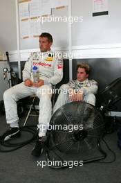 17.07.2004 Shanghai, China,  DTM, Saturday, Bernd Schneider (GER), Vodafone AMG-Mercedes, Portrait (left) and Christijan Albers (NED), DaimlerChrysler Bank AMG-Mercedes, Portrait (right), taking a break and get some refreshing air from a fan in between the Roll Out and the Free Practice - DTM Season 2004 at Pu Dong Street Circuit Shanghai (Deutsche Tourenwagen Masters)