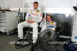 17.07.2004 Shanghai, China,  DTM, Saturday, Bernd Schneider (GER), Vodafone AMG-Mercedes, Portrait (left) and Christijan Albers (NED), DaimlerChrysler Bank AMG-Mercedes, Portrait (right), relaxing in between the Roll Out and the first Free Practice, with a refreshing wind from two large fans - DTM Season 2004 at Pu Dong Street Circuit Shanghai (Deutsche Tourenwagen Masters)