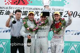 18.07.2004 Shanghai, China,  DTM, Sunday, Podium, Gary Paffett (GBR), C-Klasse AMG-Mercedes, Portrait (1st, center), Bernd Schneider (GER), Vodafone AMG-Mercedes, Portrait (2nd, left) and Mattias Ekström (SWE), Audi Sport Team Abt, Portrait (3rd, right) - DTM Season 2004 at Pu Dong Street Circuit Shanghai (Deutsche Tourenwagen Masters)