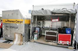 15.07.2004 Shanghai, China,  DTM, Thursday, A Lufthansa cargo box which is used as a temporary work area for Audi's gearbox technician Rainer. The sign says "Rainers Getriebe Filiale Shanghai", in both German and Chinese - DTM Season 2004 at Pu Dong Street Circuit Shanghai (Deutsche Tourenwagen Masters)