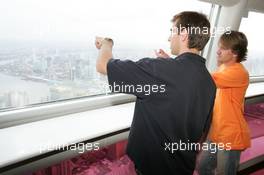 15.07.2004 Shanghai, China,  DTM, Thursday, DTM drivers Jeroen Bleekemolen (NED), OPC Euroteam, Portrait (left) and Markus Winkelhock (GER), Original-Teile AMG-Mercedes, Portrait (right), enjoying the view from a 350-meter high viewing point on the 468-meter high Oriental Pearl TV tower - DTM Season 2004 at Pu Dong Street Circuit Shanghai (Deutsche Tourenwagen Masters)