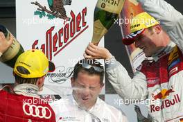 05.09.2004 Zandvoort, The Netherlands,  DTM, Sunday, The Abt team manager gets a champaign shower from Mattias Ekström (SWE), Audi Sport Team Abt, Portrait (1st, left) and Martin Tomczyk (GER), Audi Sport Team Abt, Portrait (2nd, right) - DTM Season 2004 at Circuit Park Zandvoort (Deutsche Tourenwagen Masters)