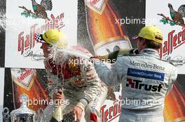 05.09.2004 Zandvoort, The Netherlands,  DTM, Sunday, Podium, Christijan Albers (NED), DaimlerChrysler Bank AMG-Mercedes, Portrait (3rd, right), gives Mattias Ekström (SWE), Audi Sport Team Abt, Portrait (1st, left), a champaign shower - DTM Season 2004 at Circuit Park Zandvoort (Deutsche Tourenwagen Masters)