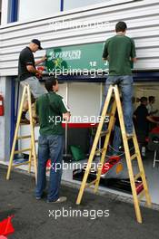 10.09.2004 Dijon, France, Friday 10 September 2004, Workers put on signs with the drivers names above the pitboxes - SUPERFUND EURO 3000 Championship Rd 7, Circuit Dijon-Prenois, France, FRA - SUPERFUND COPYRIGHT FREE editorial use only