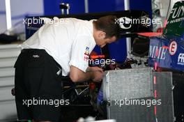 28.05.2004 Estoril, Portugal, Friday 28 May 2004, Zytek mechanic working on an engine in the back of one of the cars - SUPERFUND EURO 3000 Championship Rd 2, Estoril, Portugal, PRT - SUPERFUND COPYRIGHT FREE editorial use only