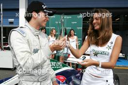 30.05.2004 Estoril, Portugal, Sunday 30 May 2004, One of the SUPERFUND grid girls hands Chistiano Tuka Rocha, BRA, Zele Racing, portrait, the trophy for the Man of the Race (in Brno), choosen by the viewers of German DSF TV and visitors of the www.superfundeuro3000.com website - SUPERFUND EURO 3000 Championship Rd 2, Estoril, Portugal, PRT - SUPERFUND COPYRIGHT FREE editorial use only
