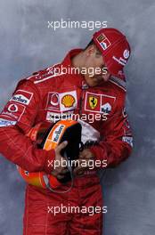 04.03.2004 Melbourne, Australia, F1, Thursday, March, Formula 1 Driver Portraits, Michael Schumacher, GER, Ferrari  sorts out his helmet. Formula 1 World Championship, Rd 1, Australian Grand Prix. www.xpb.cc, EMail: info@xpb.cc - copy of publication required for printed pictures. Every used picture is fee-liable. c Copyright: xpb.cc