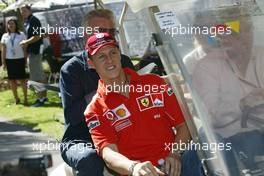 04.03.2004 Melbourne, Australia, F1, Thursday, March, Ron Walker, AUS, Australian Grand Prix Corporation Chairman drives Michael Schumacher, GER, Ferrari and Willi Weber, GER, Driver - Manager around in a golf cart. Formula 1 World Championship, Rd 1, Australian Grand Prix. www.xpb.cc, EMail: info@xpb.cc - copy of publication required for printed pictures. Every used picture is fee-liable. c Copyright: photo4 / xpb.cc - LEGAL NOTICE: THIS PICTURE IS NOT FOR ITALY  AND GREECE  PRINT USE, KEINE PRINT BILDNUTZUNG IN ITALIEN  UND  GRIECHENLAND! 