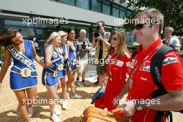 04.03.2004 Melbourne, Australia, F1, Thursday, March, Rubens Barrichello, BRA, Ferrari  has a nice welcome from the foster's girls. Formula 1 World Championship, Rd 1, Australian Grand Prix. www.xpb.cc, EMail: info@xpb.cc - copy of publication required for printed pictures. Every used picture is fee-liable. c Copyright: xpb.cc