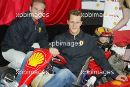 04.03.2004 Melbourne, Australia, F1, Thursday, March, Shell Press Conference with Rubens Barrichello, BRA, Ferrari and Michael Schumacher, GER, Ferrari in a two seater go kart with a child.  in the "Shell House", Formula 1 World Championship, Rd 1, Australian Grand Prix. www.xpb.cc, EMail: info@xpb.cc - copy of publication required for printed pictures. Every used picture is fee-liable. c Copyright: xpb.cc