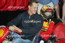 04.03.2004 Melbourne, Australia, F1, Thursday, March, Shell Press Conference with Michael Schumacher, GER, Ferrari sits in a two seater go kart with a child. in the "Shell House", Formula 1 World Championship, Rd 1, Australian Grand Prix. www.xpb.cc, EMail: info@xpb.cc - copy of publication required for printed pictures. Every used picture is fee-liable. c Copyright: xpb.cc