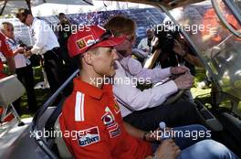 04.03.2004 Melbourne, Australia, F1, Thursday, March, Michael Schumacher, GER, Ferrari gets a lift in a golf cart with Ron Walker, AUS, Australian Grand Prix Corporation Chairman. Formula 1 World Championship, Rd 1, Australian Grand Prix. www.xpb.cc, EMail: info@xpb.cc - copy of publication required for printed pictures. Every used picture is fee-liable. c Copyright: xpb.cc