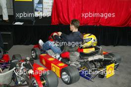 04.03.2004 Melbourne, Australia, F1, Thursday, March, Shell Press Conference with Michael Schumacher, GER, Ferrari drives around a child in a two seater go kart in the "Shell House", Formula 1 World Championship, Rd 1, Australian Grand Prix. www.xpb.cc, EMail: info@xpb.cc - copy of publication required for printed pictures. Every used picture is fee-liable. c Copyright: xpb.cc