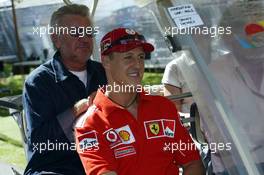 04.03.2004 Melbourne, Australia, F1, Thursday, March, Ron Walker, AUS, Australian Grand Prix Corporation Chairman drives Michael Schumacher, GER, Ferrari and Willi Weber, GER, Driver - Manager around in a golf cart. Formula 1 World Championship, Rd 1, Australian Grand Prix. www.xpb.cc, EMail: info@xpb.cc - copy of publication required for printed pictures. Every used picture is fee-liable. c Copyright: photo4 / xpb.cc - LEGAL NOTICE: THIS PICTURE IS NOT FOR ITALY AND GREECE PRINT USE, KEINE PRINT BILDNUTZUNG IN ITALIEN UND GRIECHENLAND! 
