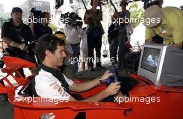 03.03.2004 Melbourne, Australia, F1, Wednesday, March, Fan Event in front of the Exibition Center,Mark Webber, AUS, Jaguar, plays on a Formula 1 computer game. Formula 1 World Championship, Rd 1, Australian Grand Prix preperations. www.xpb.cc, EMail: info@xpb.cc - copy of publication required for printed pictures. Every used picture is fee-liable. c Copyright: xpb.cc