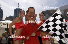 03.03.2004 Melbourne, Australia, F1, Wednesday, March, A Michael Schumacher, GER, Ferrari  look a like poses with a couple of Australian Girls. Formula 1 World Championship, Rd 1, Australian Grand Prix preparations. www.xpb.cc, EMail: info@xpb.cc - copy of publication required for printed pictures. Every used picture is fee-liable. c Copyright: xpb.cc