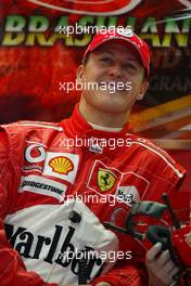 23.10.2004 Interlagos, Brazil, F1, Saturday, October, Michael Schumacher, GER, Ferrari watches the dog on the TV which ran onto the circuit - Formula 1 World Championship, Rd 18, Brazilian Grand Prix, BRA, Brazil, Practice