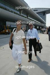 23.09.2004 Shanghai, China, F1, Thursday, September, Michael Schumacher, GER, Ferrari arrives at the circuit with Willi Weber, GER, Driver - Manager - Formula 1 World Championship, Rd 16, Chinese Grand Prix, CHN, China