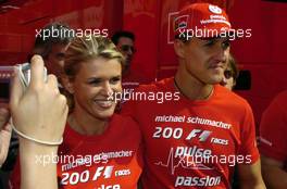 09.05.2004 Barcelona, Spain, F1, Sunday, May, Michael Schumacher, GER, Ferrari with his wife Corina Schumacher, GER, Corinna, wife of Michael Schumacher, after the race (with a shirt - 200 F1 races, pulse passion) - Formula 1 World Championship, Rd 5, Marlboro Spanish Grand Prix Race, ESP