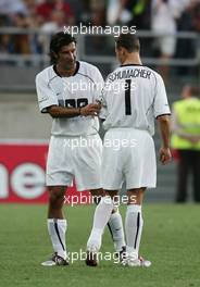 12.07.2004 Faro, Portugal, Luis Figo and Michael Schumacher, GER, Ferrari - Michael Schumacher, Formula One World Champion, plays in the 2004 ALLSTARS GAME at the Algarve Stadium (Faro/Loule) on July 12th - Funds raised will go to LUIS FIGO FOUNDATION and LAUREUS SPORT FOR GOOD FOUNDATION