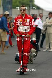 02.07.2004 Magny Cours, France, F1, Friday, July, Michael Schumacher, GER, Ferrari, on a elektro Scooter - Formula 1 World Championship, Practice, Rd 10, Grand Prix de France, Circuit Nevers, FRA