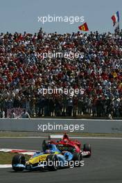 04.07.2004 Magny Cours, France, F1, Sunday, July, Fernando Alonso, ESP, Mild Seven Renault F1 Team, R24, Action, Track leads Michael Schumacher, GER, Scuderia Ferrari Marlboro, F2004, Action, Track - Formula 1 World Championship, Race, Rd 10, Grand Prix de France, Circuit Nevers, FRA