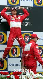 11.07.2004 Silverstone, England, F1, Sunday, July, JUMP, Michael Schumacher, GER, Ferrari, Rubens Barrichello, BRA, Ferrari - Formula 1 World Championship, Rd 11, British Grand Prix, Podium, Silverstone, GBR