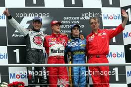 25.07.2004 Hockenheim, Germany, F1, Sunday. July, Jenson Button, GBR, BAR Honda, Michael Schumacher, GER, Ferrari, Fernando Alonso, ESP, Renault F1 Team, Paolo Martinelli, ITA, Ferrari, engine development, Portrait - Formula 1 World Championship, Rd 12, Podium, Grosser Mobil 1 Preis von Deutschland, GER, Hockenheimring Baden-Württemberg