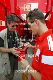 24.07.2004 Hockenheim, Germany, F1, Saturday, July, Michael Schumacher, GER, Ferrari autographs a model car - Formula 1 World Championship, Rd 12, Grosser Mobil 1 Preis von Deutschland, GER, Hockenheimring Baden-Württemberg