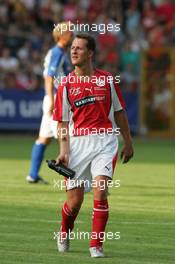 21.07.2004 Mannheim, Deutschland, "Spiel des Herzens", here: Michael Schumacher, GER, Ferrari with a TATTOO on teh right arm - Fair Play für Kinder in Not at Carl-Benz-Stadion Mannheim, the F1 Superstars (Michael Schumacher) plays against the RTL-Superstars, Charity, RTL Stiftung "Kinder in Not", UNESCO, before the Formula 1 World Championship, Rd 12, Grosser Mobil 1 Preis von Deutschland, GER, Hockenheimring Baden-Württemberg