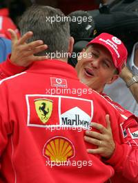 14.08.2004 Budapest, Hungary, F1, Saturday, August, Ross Brawn, GBR, Ferrari, Technical Director, Portrait and Michael Schumacher, GER, Ferrari, waving to the fans after winning the pole - Formula 1 World Championship, Qualifying, Rd 13, Hungarian Grand Prix, HUN, Hungaroring