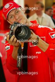 10.09.2004 Monza, Italy F1, Friday, September, Michael Schumacher, GER, Ferrari with an Olympus camera - Formula 1 World Championship, Rd 15, Italian Grand Prix, ITA, Italy