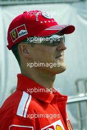 09.09.2004 Monza, Italy, F1, Thursday, September, Michael Schumacher, GER, Ferrari arrives at the paddock, wearing his NEW "7times world champion cap" - Formula 1 World Championship, Rd 15, Italian Grand Prix, ITA, Italy