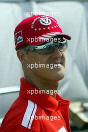 09.09.2004 Monza, Italy, F1, Thursday, September, Michael Schumacher, GER, Ferrari arrives at the paddock, wearing his NEW "7times world champion cap" - Formula 1 World Championship, Rd 15, Italian Grand Prix, ITA, Italy