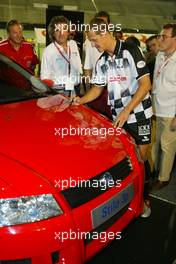 08.09.2004 Monza, Italy F1, Wednesday, September, Michael Schumacher, GER, Ferrari autographed a limited edition Michael Schumacher Fiat Stilo - Charity football match, Stadio Brianteo, Formula 1 World Championship, ITA, Italy