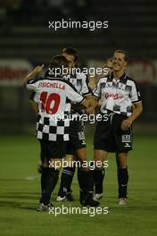 08.09.2004 Monza, Italy F1, Wednesday, September, Giancarlo Fisichella, ITA scores a goal and celebrates with Michael Schumacher, GER, Ferrari - Charity football match, Stadio Brianteo, Formula 1 World Championship, ITA, Italy