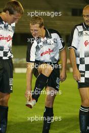 08.09.2004 Monza, Italy F1, Wednesday, September, Michael Schumacher, GER, Ferrari talks about his Adidas boots - Charity football match, Stadio Brianteo, Formula 1 World Championship, ITA, Italy