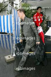 08.10.2004 Suzuka, Japan, F1, Friday, October, Michael Schumacher, GER, Ferrari arrives at the circuit whilst it is raining, he also has the Italian flag on the arm of his jacket  - Formula 1 World Championship, Rd 17, Japanese Grand Prix, JPN, Japan, Practice