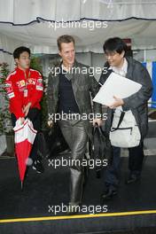 08.10.2004 Suzuka, Japan, F1, Friday, October, Michael Schumacher, GER, Ferrari arrives at the circuit whilst it is raining - Formula 1 World Championship, Rd 17, Japanese Grand Prix, JPN, Japan, Practice