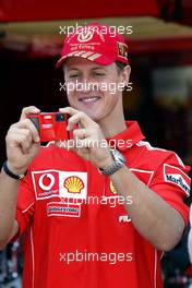 19.05.2004 Monte Carlo, Monaco, F1, Wednesday, May, Michael Schumacher, GER, Ferrari takes a picture with the new Ferrari Olympus digital camera - Formula 1 World Championship, Rd 6, Monaco Grand Prix, MCO