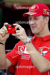 19.05.2004 Monte Carlo, Monaco, F1, Wednesday, May, Michael Schumacher, GER, Ferrari takes a picture with the new Ferrari Olympus digital camera - Formula 1 World Championship, Rd 6, Monaco Grand Prix, MCO