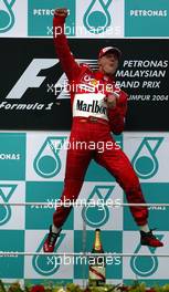 21.03.2004 Sepang, Malaysia, F1, Sunday, March, Michael Schumacher, GER, Ferrari, with his JUMP, Formula 1 World Championship, Podium, Rd 2, Malaysian Grand Prix, KUL, Kuala Lumpur