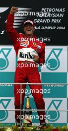 21.03.2004 Sepang, Malaysia, F1, Sunday, March, Michael Schumacher, GER, Ferrari, with his JUMP, Formula 1 World Championship, Podium, Rd 2, Malaysian Grand Prix, KUL, Kuala Lumpur