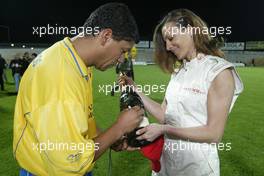 21.04.2004 Forli, Italy, QIS, Charity football match at Stadio Morgani / Forli between current and former F1 drivers, and the Brazilian 1994 Soccer team, a Brazilian player signs a Champagne Mumm Jeroboam which has been signed by the drivers and Brazilians who played in the football match. The Jeroboam will be auctioned for charity. Wednesday, April, Formula 1 World Championship, Rd 4, San Marino Grand Prix, RSM - Mumm Copyright Free