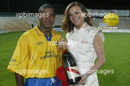 21.04.2004 Forli, Italy, QIS, Charity football match at Stadio Morgani / Forli between current and former F1 drivers, and the Brazilian 1994 Soccer team, a Brazilian player poses with a Champagne Mumm Jeroboam which has been signed by the drivers and Brazilians who played in the football match. The Jeroboam will be auctioned for charity. Wednesday, April, Formula 1 World Championship, Rd 4, San Marino Grand Prix, RSM - Mumm Copyright Free