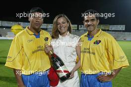21.04.2004 Forli, Italy, QIS, Charity football match at Stadio Morgani / Forli between current and former F1 drivers, and the Brazilian 1994 Soccer team, 2 Brazilian players pose with a Champagne Mumm Jeroboam which has been signed by the drivers and Brazilians who played in the football match. The Jeroboam will be auctioned for charity. Wednesday, April, Formula 1 World Championship, Rd 4, San Marino Grand Prix, RSM - Mumm Copyright Free