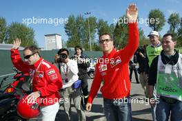 25.04.2004 Imola, San Marino, F1, Sunday, April, Rubens Barrichello, BRA, Ferrari and Michael Schumacher, GER, Ferrari arrive at the track side with a scooter - Podium, Formula 1 World Championship, Rd 4, San Marino Grand Prix, RSM