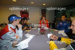 04.12.2004 Paris, France,  Saturday, Some of the drivers sitting together with from left to right: Mattias Ekstrom (SWE), DTM driver, Team Abt-Audi, Portrait, Marcus Gronholm (FIN), WRC driver, Team Peugeot Sport, Portrait, Stephane Sarrazin (FRA), Rally driver, Team Subaru France/FFSA, Portrait and Heikki Kovalainen (FIN), World Series by Nissan driver, Team RDD, Portrait - 17th Race of Champions 2004, Stade de France, Paris, France